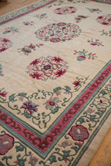 Vintage Japanese Peking rug corner: ivory field, full pile, pink, blue, green floral and cloudband motifs.