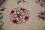 Japanese Peking rug minor medallion with pink, green, blue floral and cloudband motifs.