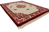 Plush red butterfly and plant motifs on ivory Peking rug border with fringe.