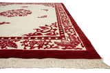Peking rug's plush pile, cherry red germinating plant, pearl border, and ivory fringe.