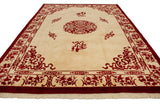 Ivory and cherry red Peking rug corner with vine, geometric border, and fringe.