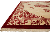 Plush ivory and cherry red Indian Peking carpet corner, showing flora, cloudbands, and fringe.