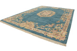 Indian Aubusson design rug corner, sky blue field, pale gold floral patterns, and ivory fringe.