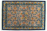Indian Arts and Crafts carpet with beige field, sprawling blue vinery, gold flowers.