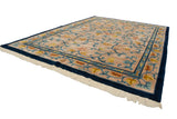 Vintage Indian Arts and Crafts rug with beige field, cobalt vinery, blossoming buds, and fringe.