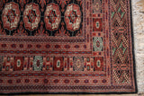Detailed geometric borders, intact side selvage, and ivory fringe on a vintage Bokhara carpet.