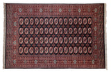 Fine vintage Bokhara carpet with plush brick red gul medallions on a deep navy field.