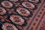 Bokhara rug's fine weave reveals brick red gul medallions and intricate geometric border.