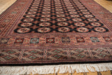 An angled perspective showing the fine weave and lustrous pile of a vintage Bokhara carpet.