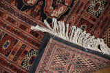 Corner of a fine Bokhara carpet showing the hand-knotted foundation and original ivory fringe.