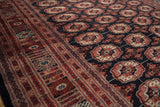 Lustrous wool pile of a fine Bokhara carpet, highlighting the intricate border and geometric gul medallions.