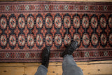 A standing view of a fine Bokhara runner, showing the plush texture and repeating gul pattern.