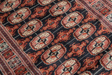 Angled view highlighting the plush, lustrous pile and fine weave of a vintage Bokhara rug.