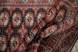 The soft, lustrous pile and fine weave detail of a vintage Bokhara rug's gul medallions.