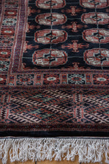 Plush wool pile, intricate Bokhara gul medallions, and clean white fringe.
