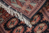 Cream fringe, dark selvage detail, and brick red gul medallions with antique ivory.
