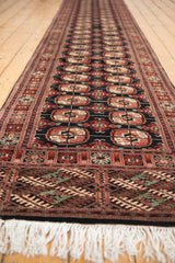 Plush Bokhara runner showcasing rust, ivory gul medallions, geometric borders, and white fringe.