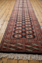 Ivory fringe and intricate geometric border in rust, black, and cream on a vintage Bokhara runner.