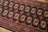 Plush, fine pile of vintage Bokhara runner with rust, ivory gul medallions.