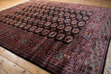 Finely woven geometric border and original ivory fringe on a vintage Pakistani Bokhara carpet corner.