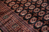 Lustrous, plush pile of a fine Bokhara carpet, with detailed brick red and navy geometric borders.