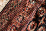 Plush, high-sheen wool pile, ivory fringe, and geometric guls on a vintage Bokhara carpet.