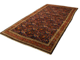 Fine antique Persian Bijar carpet with an allover rose bouquet motif in madder red and gold on a navy blue field.