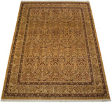 Angled view of a vintage Pakistani Kerman carpet showing its floral and lovebird pattern.