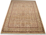 Vintage Pakistani Kerman carpet from an angle, showing lovebirds within a floral blossom pattern.