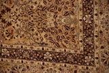 Corner detail of a vintage Kerman rug showing lovebirds, floral vines, and cherry red borders.