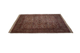 Angled view of Vintage Kerman carpet, ivory field floral palmettes, cochineal red border with vine motif.