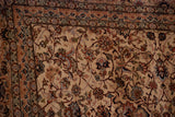 Intricate floral vinery on the ivory field and border of a vintage Pakistani carpet.