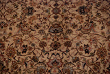 Intricate floral vinery in navy and terra cotta on the plush, hand-knotted wool pile of a vintage carpet.