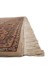 Intact side cord selvage and full wool pile on a vintage Isfahan design carpet with ivory fringe.