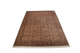 Full length angled view of a vintage Pakistani Isfahan design rug with dense floral patterns.