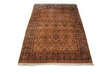 Vintage Kerman carpet showing ivory floral field and palmette border in oxidized silver.