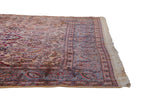 Kerman carpet corner with ivory floral field, blue palmette border, and weaver's signature.