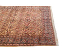 Traditional Kerman carpet with ivory field, burgundy floral sprays, and oxidized silver palmette border.