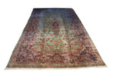 Vintage Kerman carpet with mint green field, central medallion, and red, navy floral design.