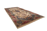 Oversize vintage Kerman carpet with a floral medallion on an ivory field and a contoured red and denim blue border.