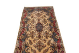 Angled view of an oversize vintage Kerman carpet, showing its full pile and floral design length.