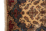 A vintage Kerman's contoured blue and rose border against an ivory field with floral sprays.