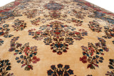 Angled view across the plush, full pile of a vintage Kerman carpet showing its floral sprays.
