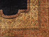 Fine Kerman carpet corner showing the Rococo border separating its navy and ivory floral fields.