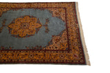 Corner spandrel and saffron border detail on a vintage Romanian Tabriz design carpet with a powder blue field.