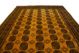 Saffron yellow Daulatabad carpet detail showcasing charcoal elephant's footprint guls and hook-and-latch motifs.