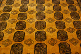 Saffron yellow field with intricate charcoal elephant's footprint gul and diamond motifs.