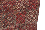 Angled view of the antique Beshir carpet, detailing the geometric panel design and original selvage.