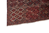 Corner detail of an antique Beshir carpet showing its hand-knotted fringe and original side cord selvage.