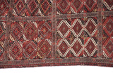 Evenly worn pile and geometric end border of a fine Turkmen Beshir collector carpet.